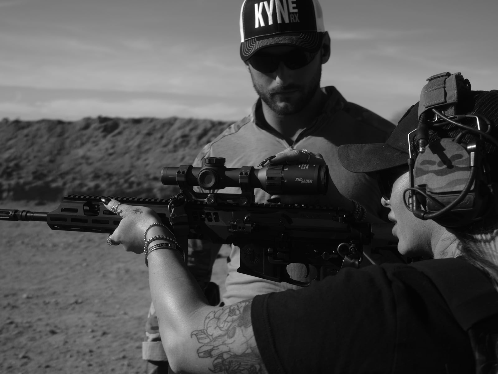 Range training - shooter aiming an AR with optic, KyneRx instructor coaching